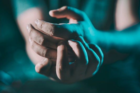 a close up of a person holding their hands together