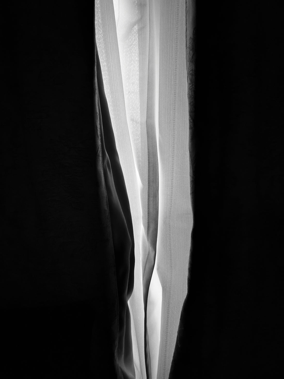 a black and white photo of a curtain