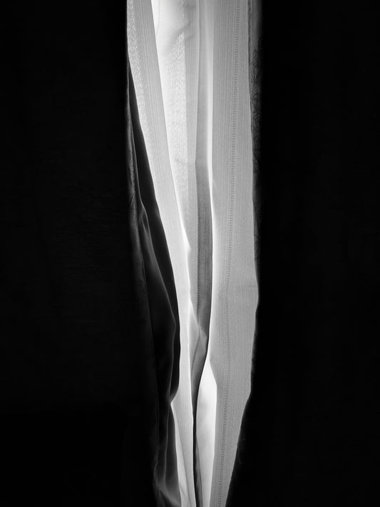 a black and white photo of a curtain