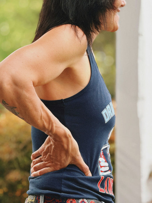 Woman with muscular arms holding her back