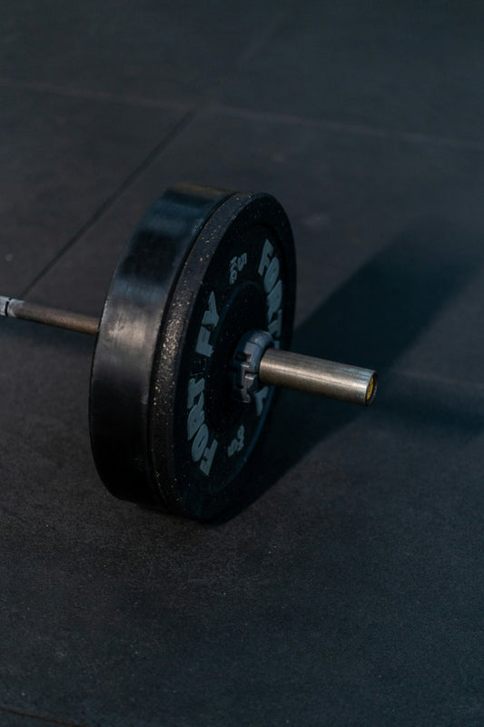 A close-up of a barbell weight on a gym floor